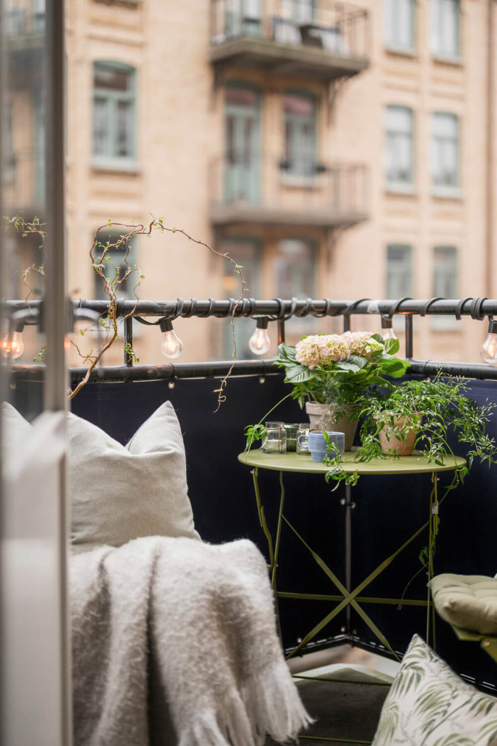 An Early 20th-Century Apartment with a Pink Kitchen 17 balcony string lights