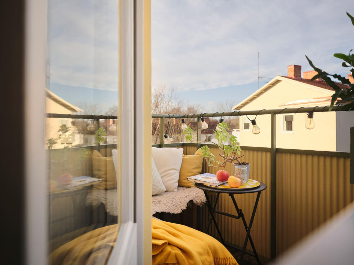 A Small, Light Swedish Apartment with Midcentury Features 8 balcony yellow textiles