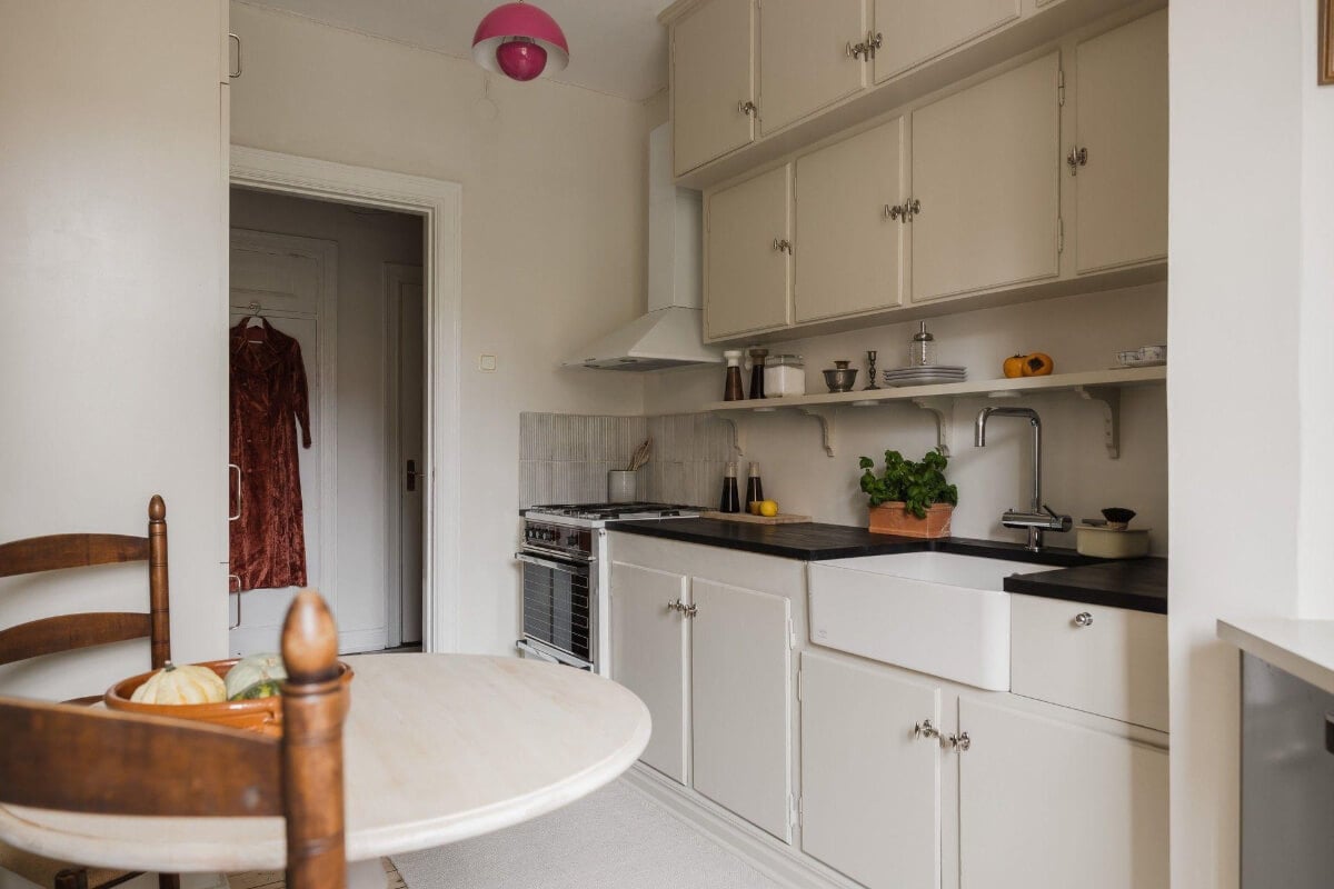 Natural Tones and Original Elements in a 1930s Apartment 10 beige kitchen with pink pendant