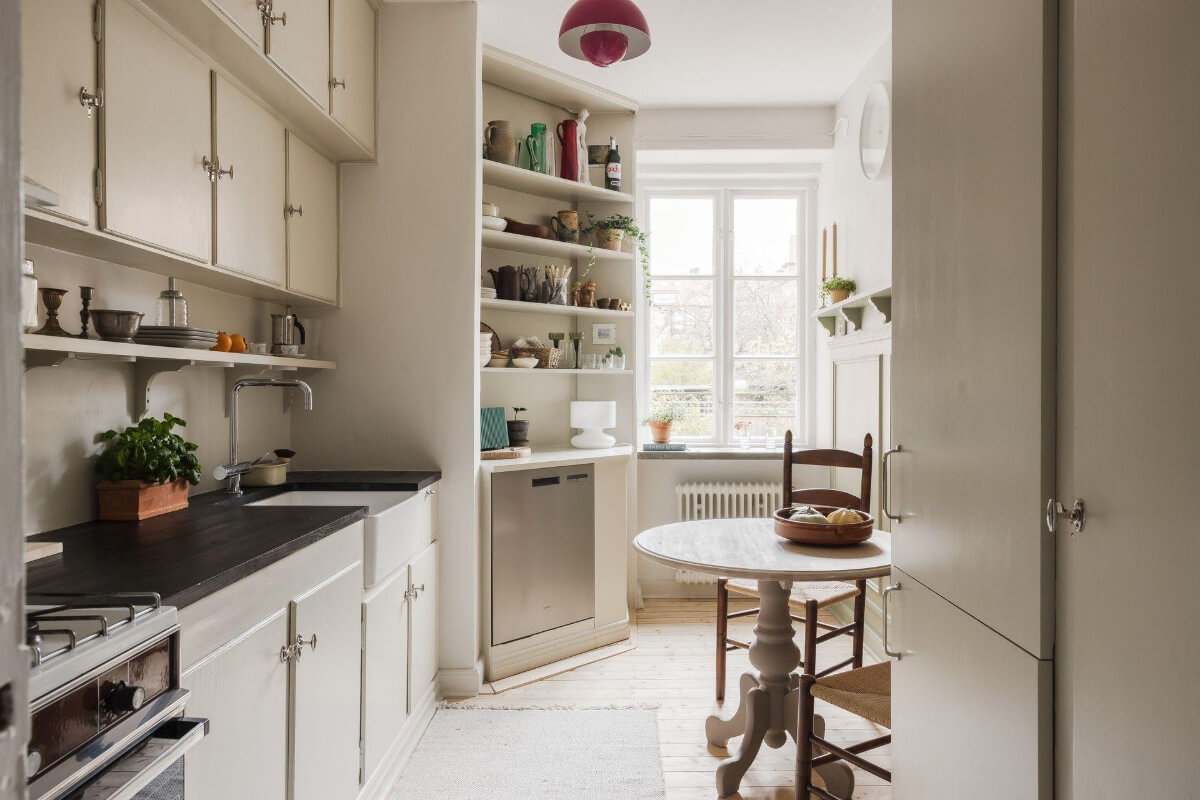 Natural Tones and Original Elements in a 1930s Apartment 6 beige kitchen with round wooden table