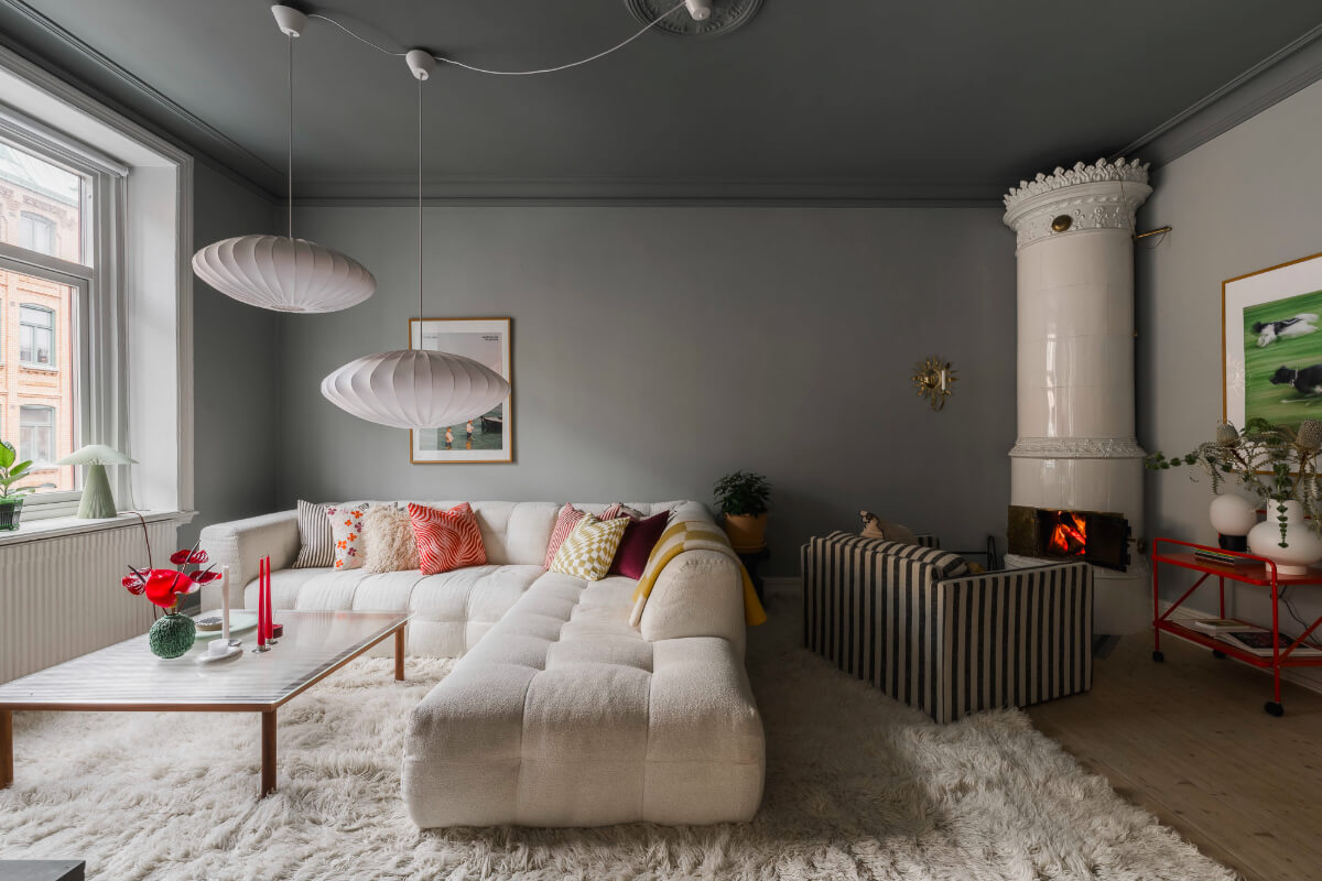 An Early 20th-Century Apartment with a Pink Kitchen 1 color drenched gray living room striped sofa fireplace