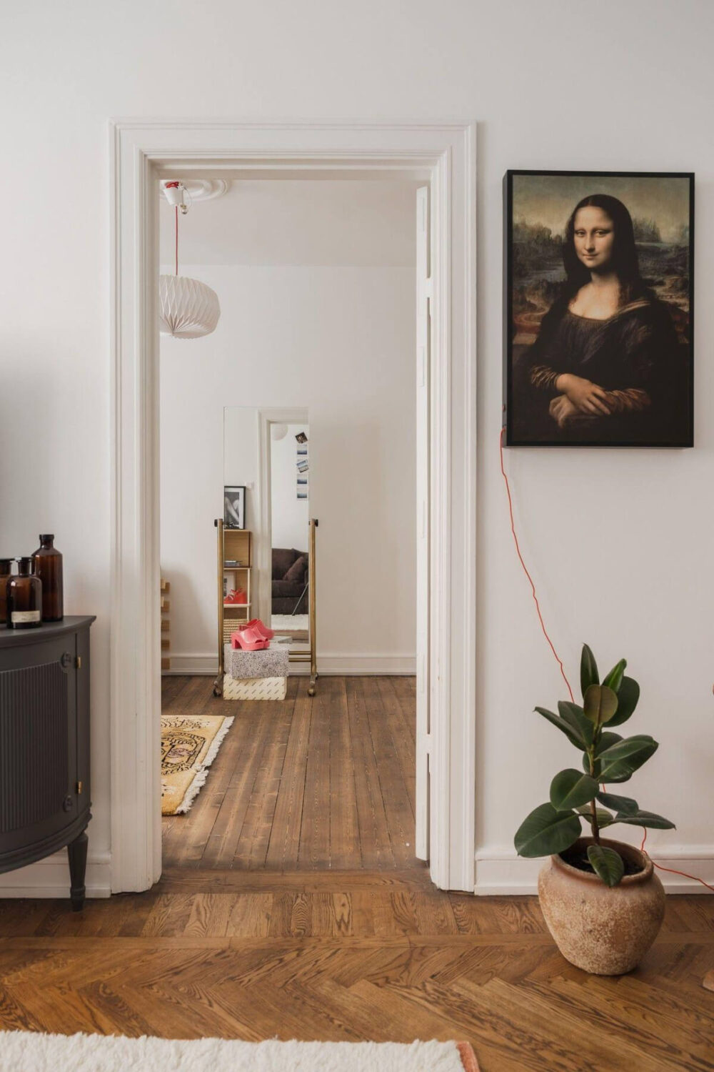 Natural Tones and Original Elements in a 1930s Apartment 13 doorway dark stained wooden floor