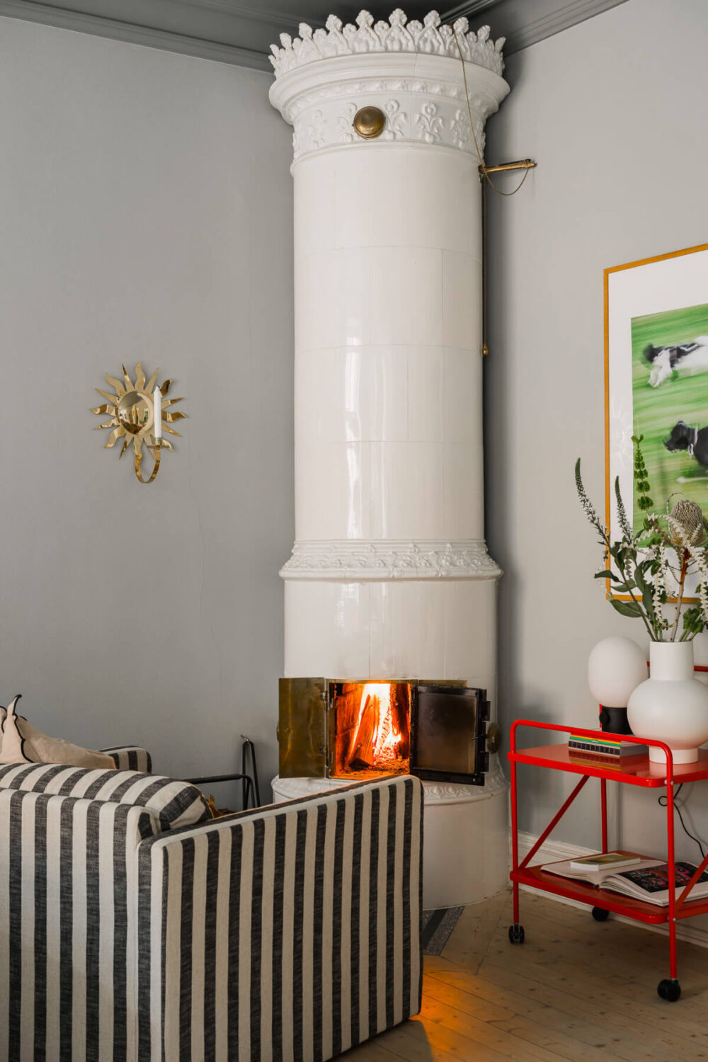 An Early 20th-Century Apartment with a Pink Kitchen 3 fireplace sitting nook striped chair