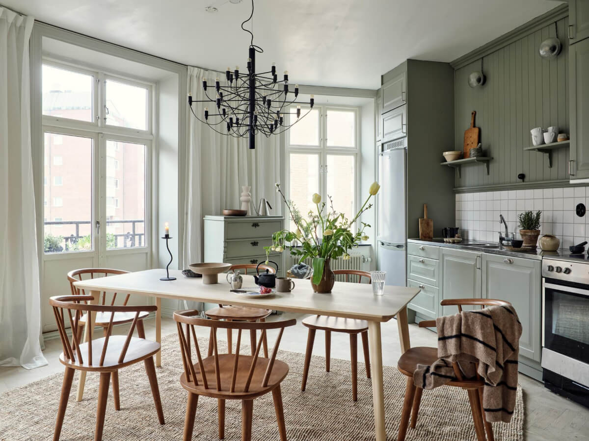 A Light Scandi Apartment in a Former Stately Home 9 green kitchen with large table