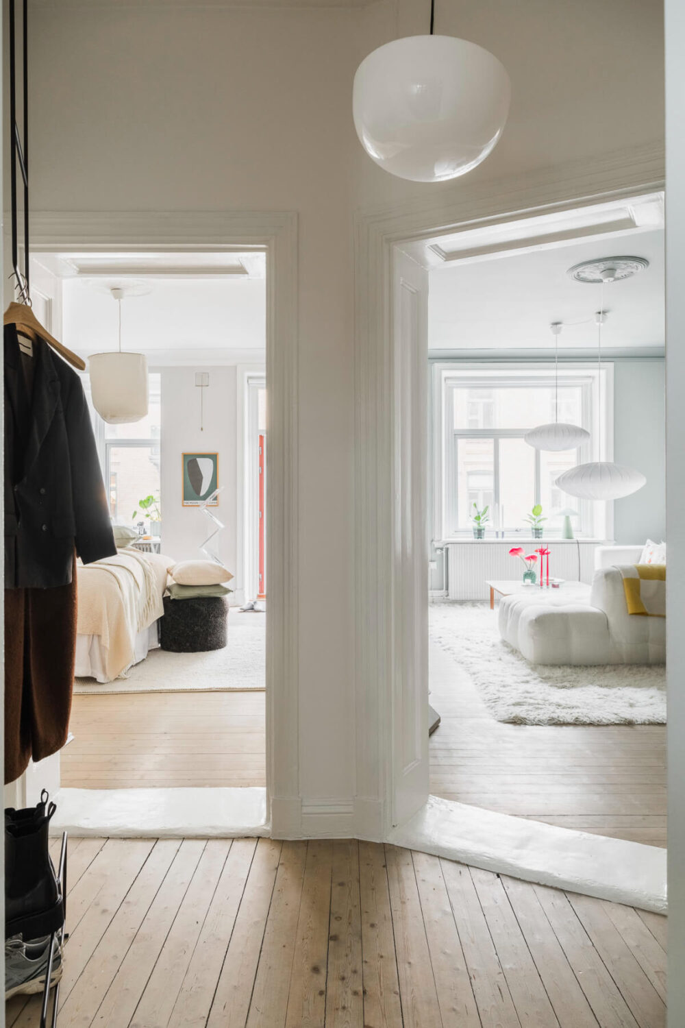 An Early 20th-Century Apartment with a Pink Kitchen 22 hallway wooden floor