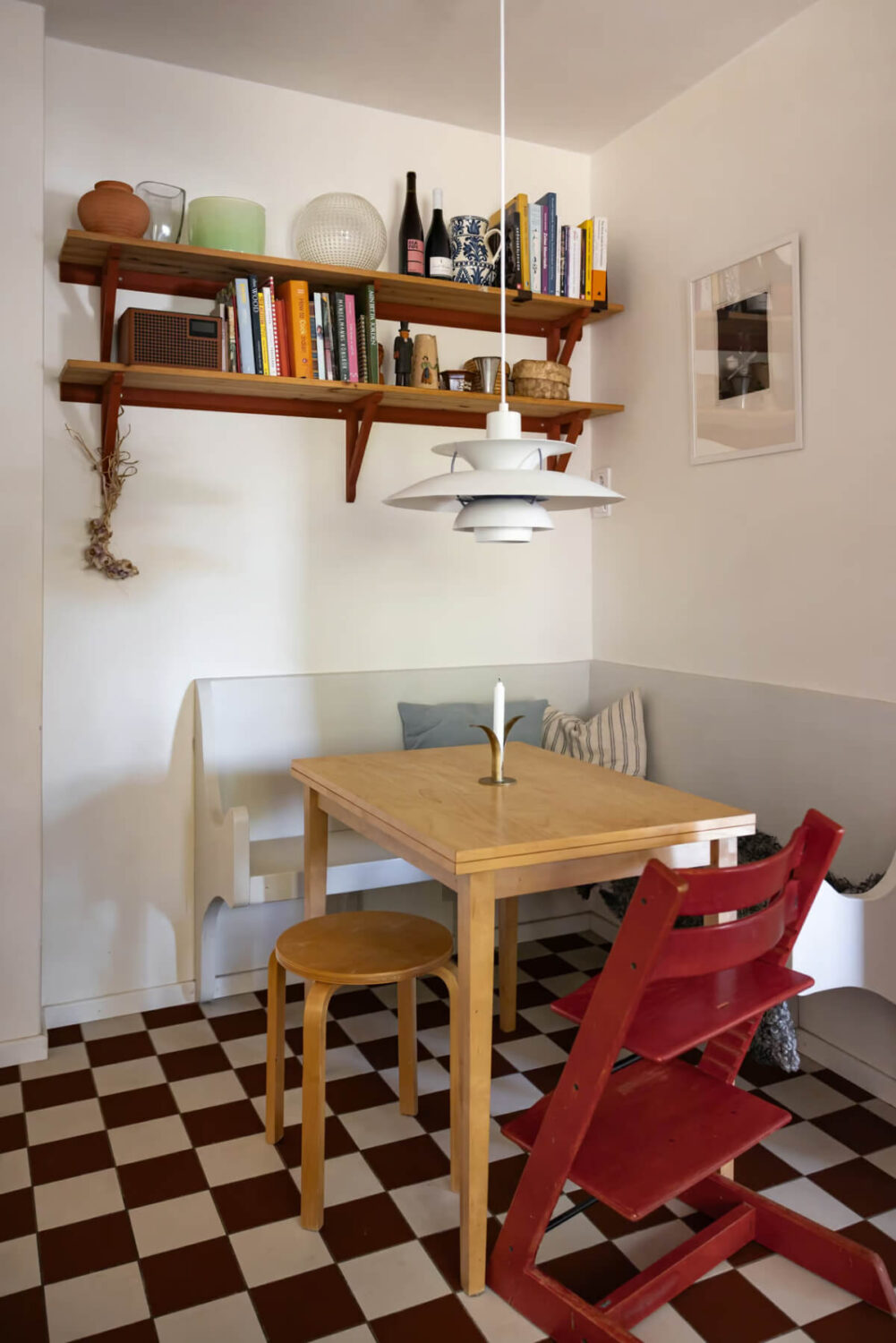 A Cozy Swedish Apartment in a 1950s Building 14 kitchen breakfast nook with bench and checkerboard floor