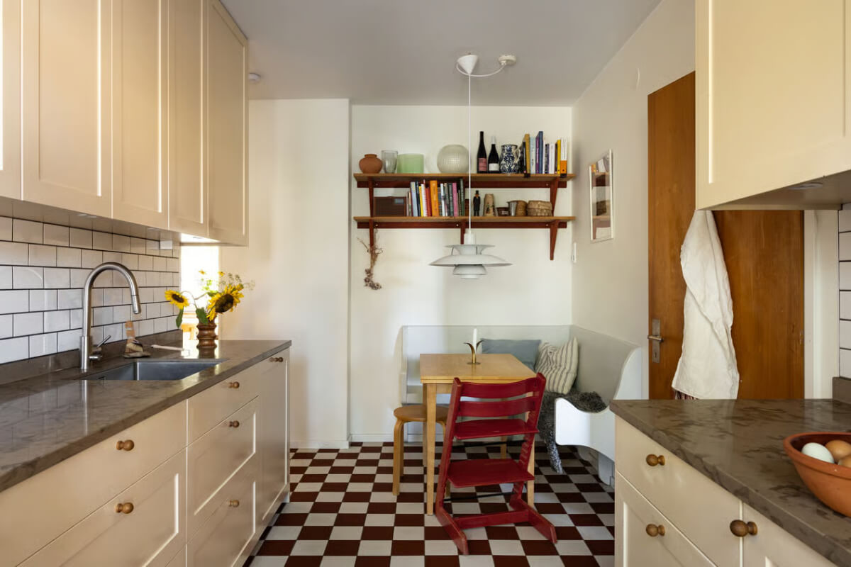 A Cozy Swedish Apartment in a 1950s Building 9 kitchen breakfast table with bench and checkerboard floor