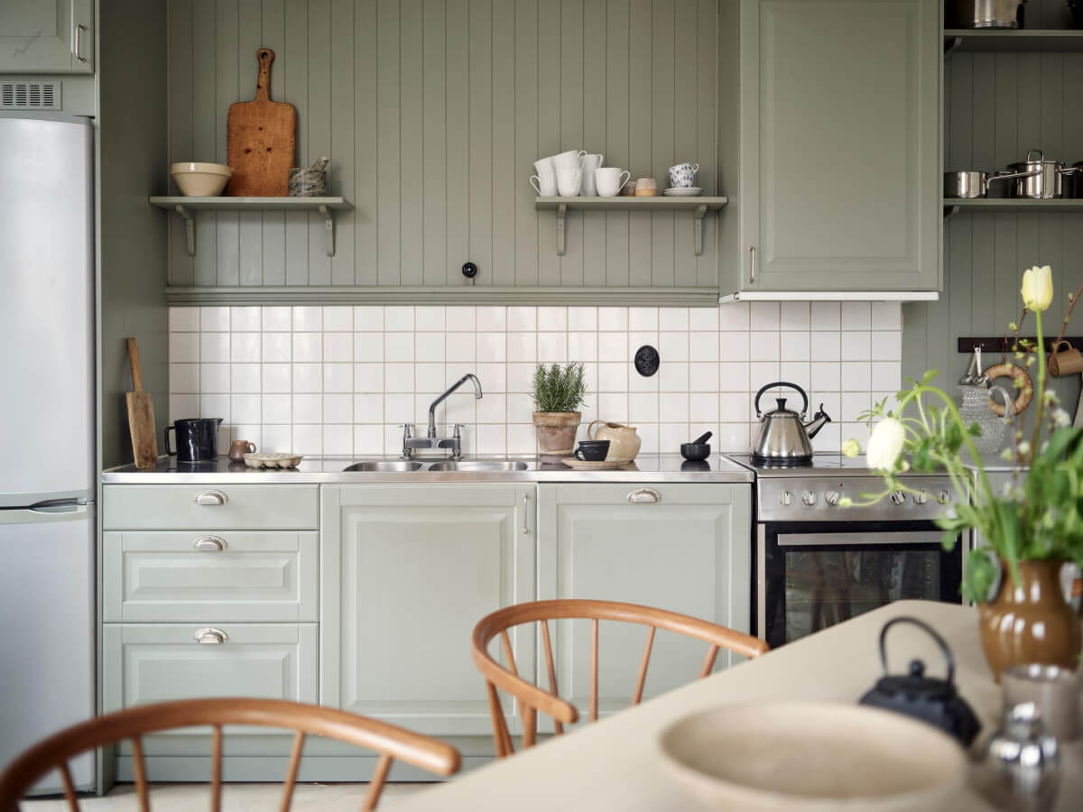 A Light Scandi Apartment in a Former Stately Home 10 kitchen gray-green cabinets white tiles
