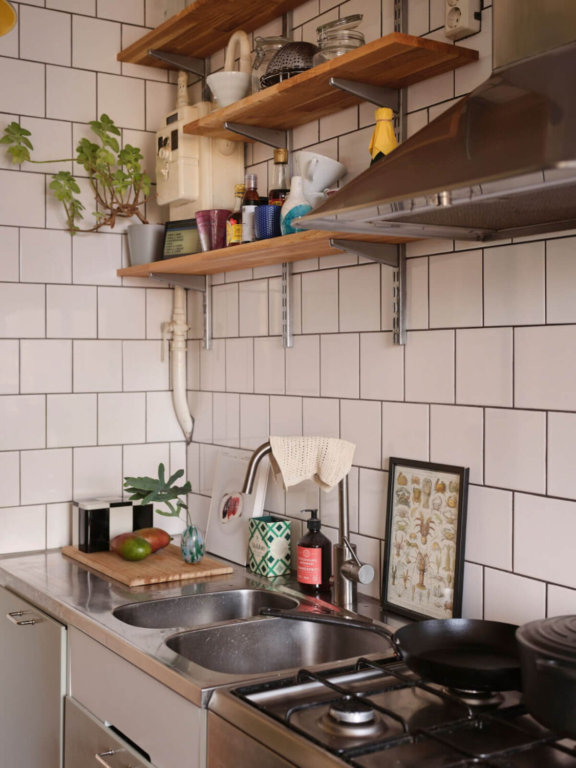 A Small, Light Swedish Apartment with Midcentury Features 17 kitchen with shelves and white tiles