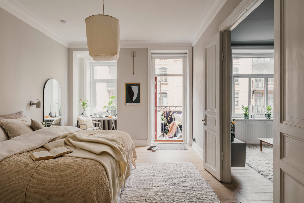An Early 20th-Century Apartment with a Pink Kitchen 15 light bedroom with balcony