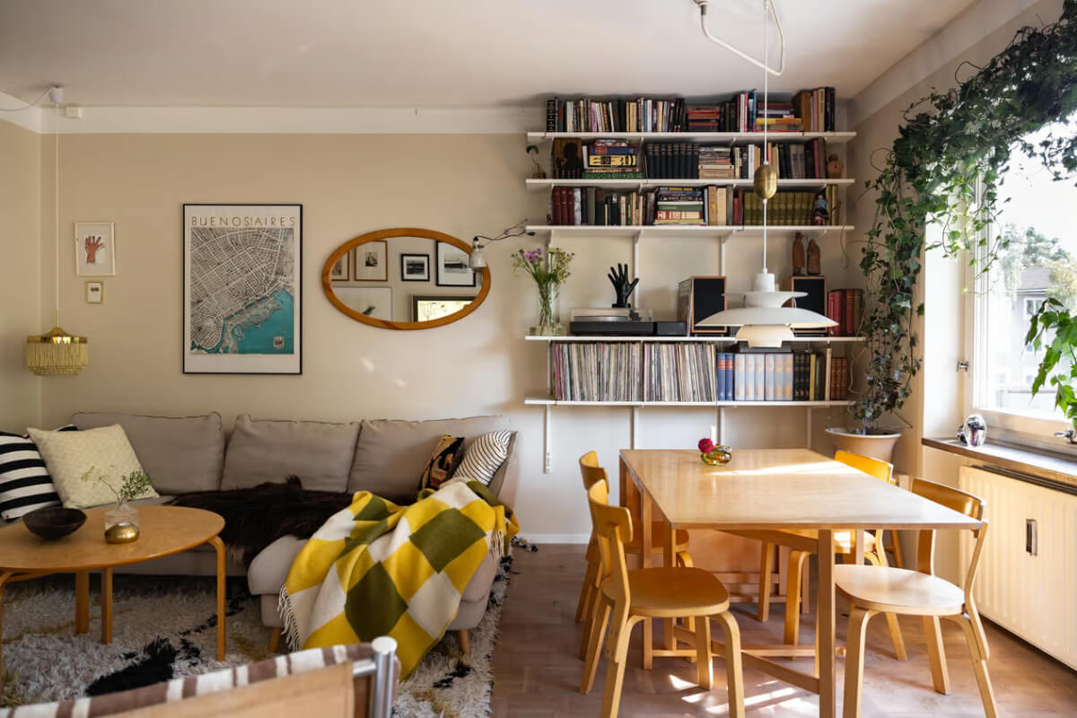 A Cozy Swedish Apartment in a 1950s Building 4 living room beige walls dining table shelves