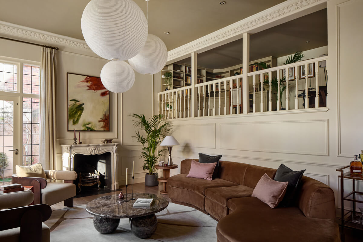 living room curved brown sofa fireplace loft space