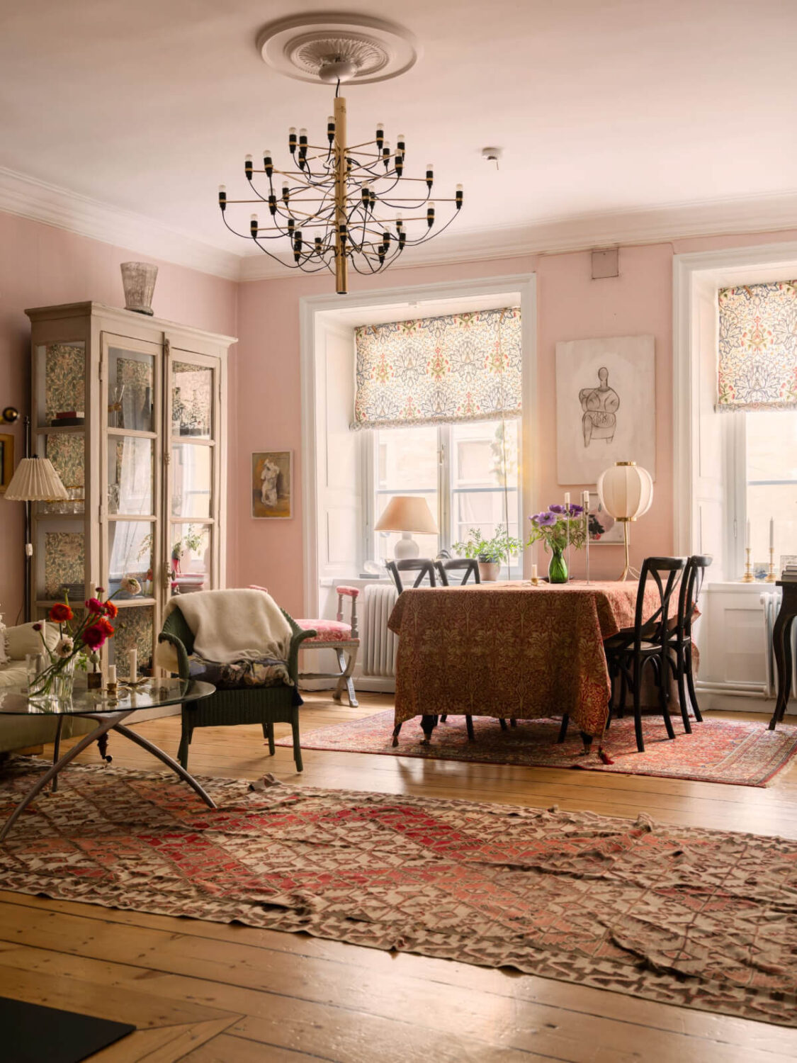 living room light pink walls wide floorboards large rugs
