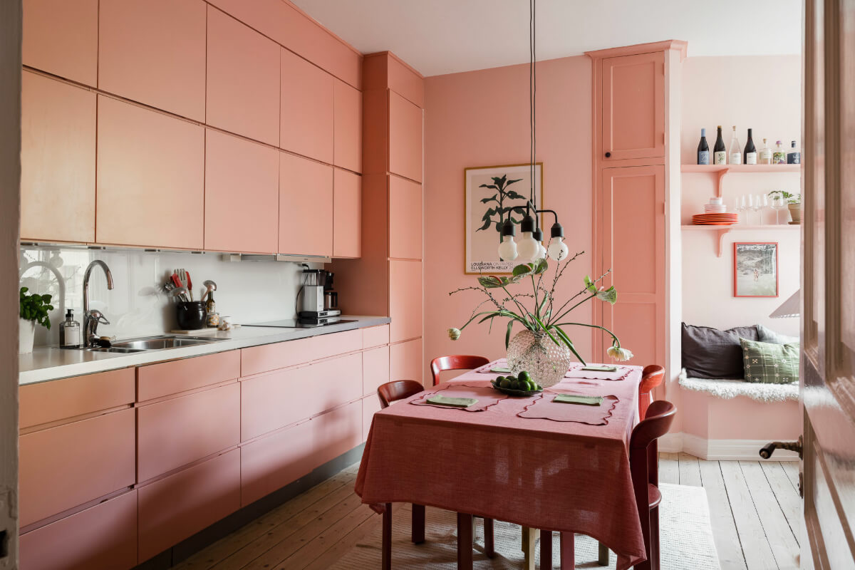 An Early 20th-Century Apartment with a Pink Kitchen 24 pink kitchen large table scandi apartmetn
