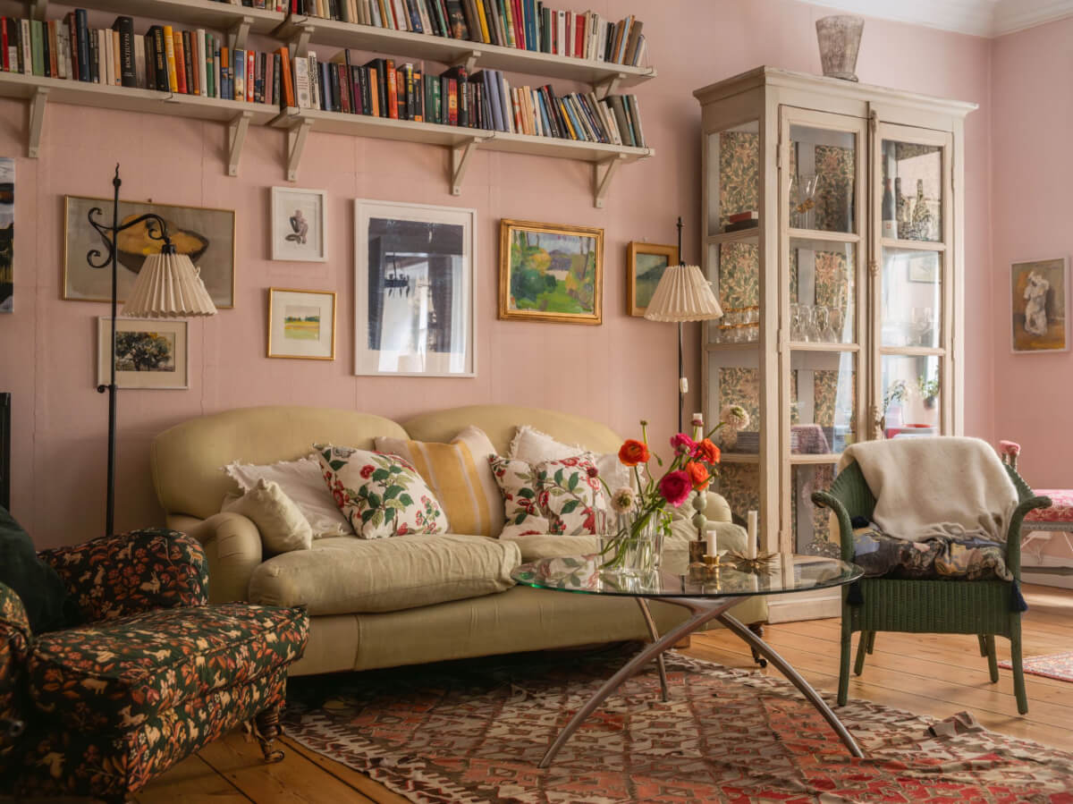 pink living room with bookshelves