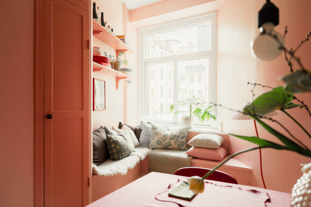 An Early 20th-Century Apartment with a Pink Kitchen 29 pink window seat layered cushions