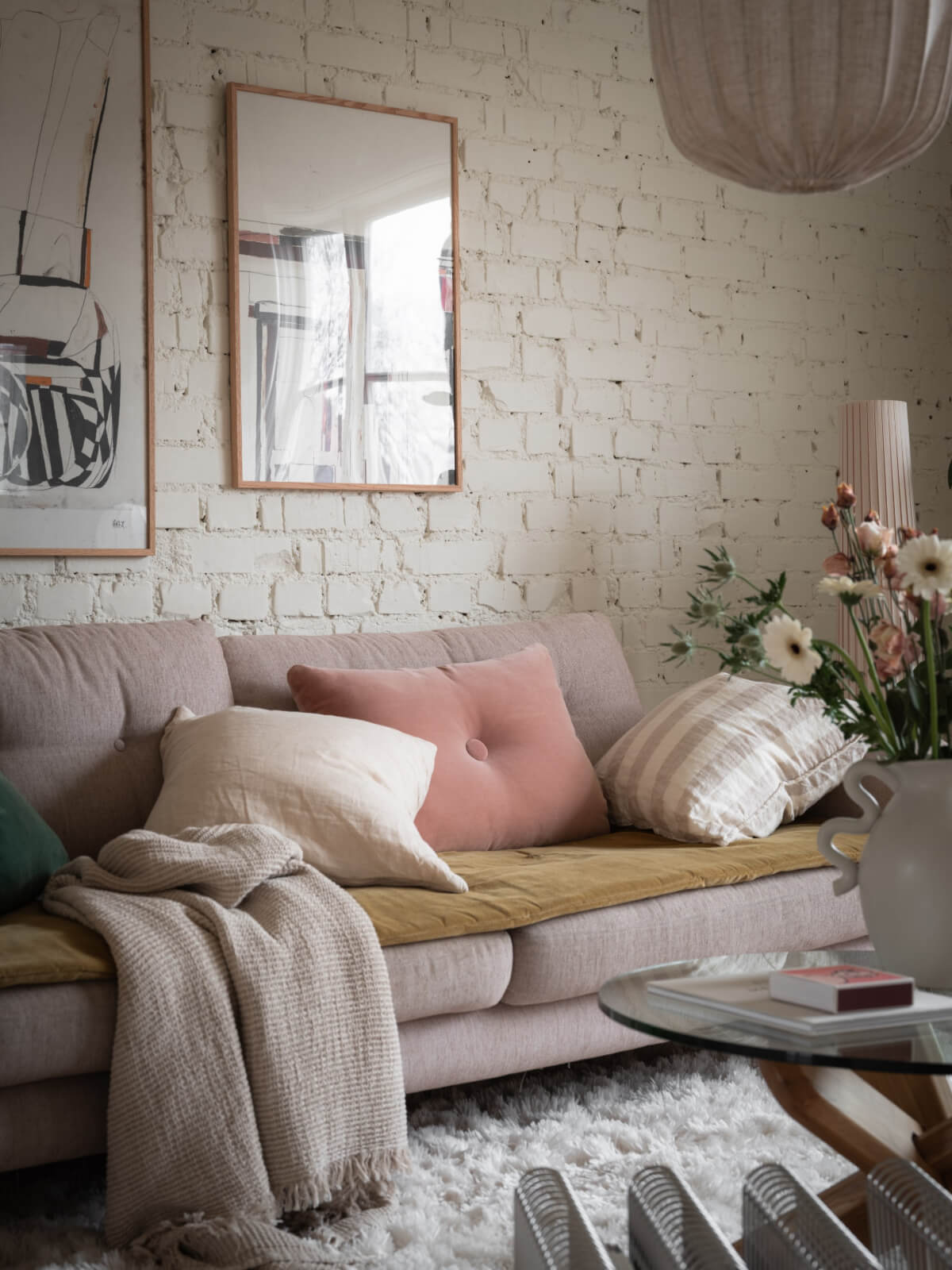 sofa muted color accents white painted brick wall nordroom