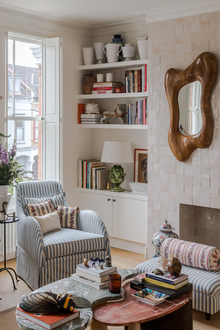 striped armchair bookshelves large windows living room