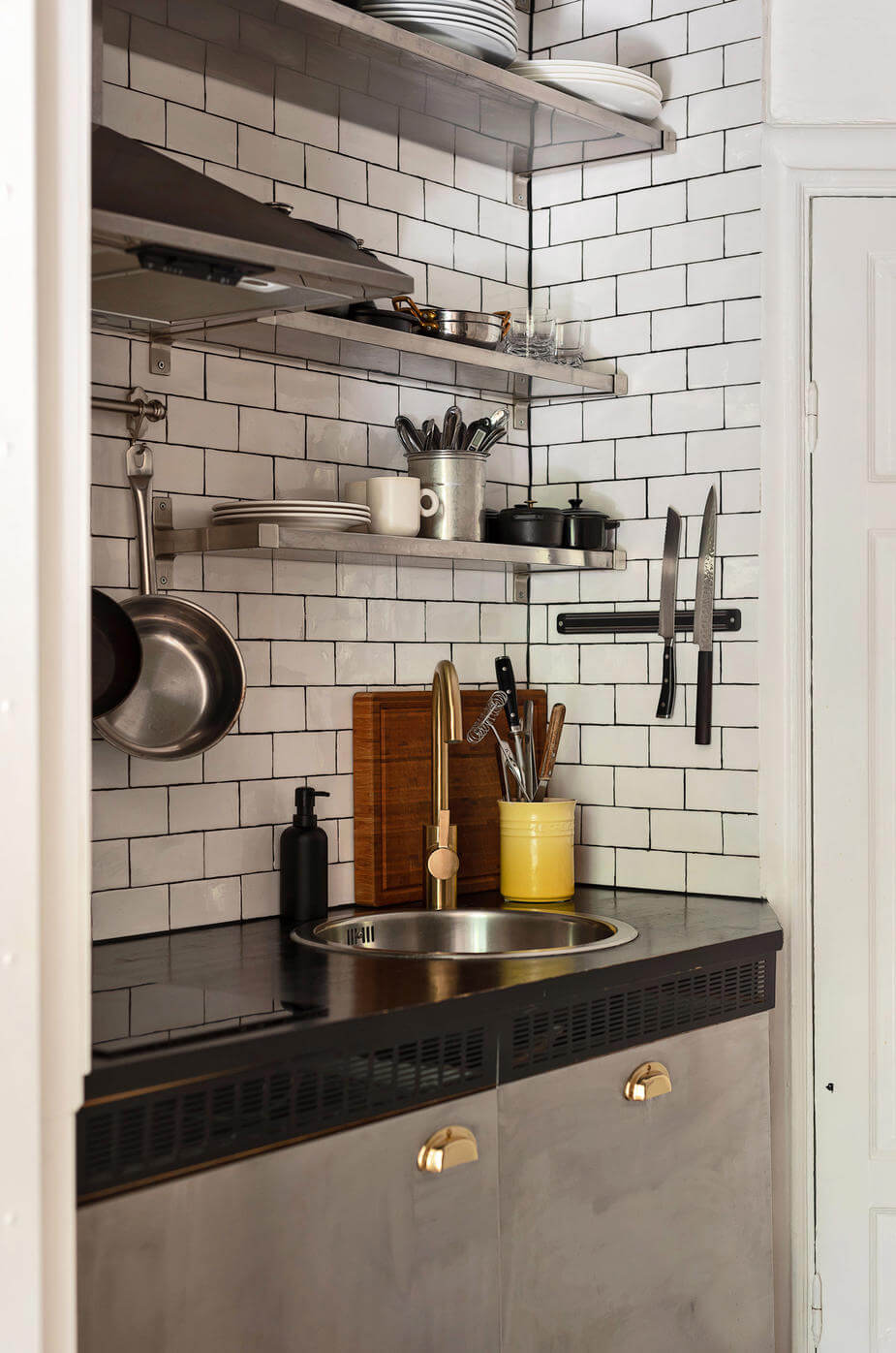 A Charming Studio Apartment with Leafy Courtyard Views 10 tiny stainless steel kitchen subway tiles