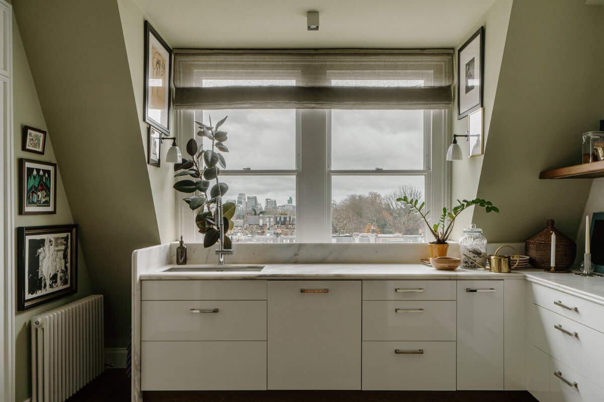 white kitchen with marble countertop and olive green walls