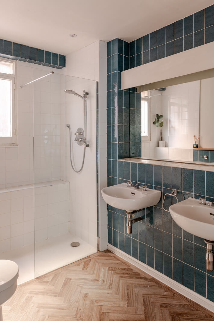 A Light Duplex Apartment in an Arts and Crafts Building 19 bathroom blue tiles herringbone floor