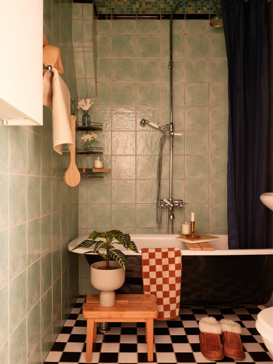 A Two-Bedroom Apartment with a Charming Bathroom 20 bathroom green wall tiles checkerboard floor freestanding bath