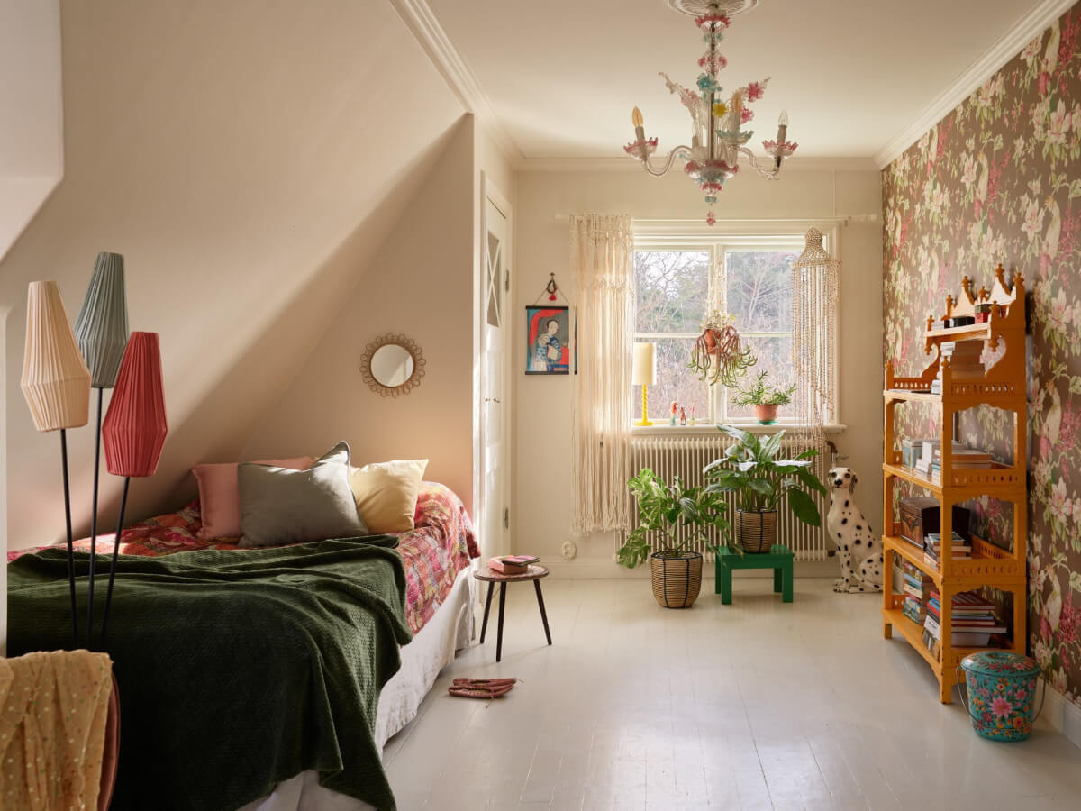 bedroom slanted ceiling white floorboards floral wallpaper