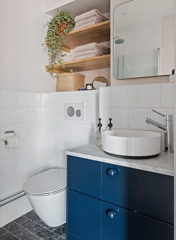 A Stockholm Apartment with a Light Yellow Kitchen 23 blue bathroom vanity round sink