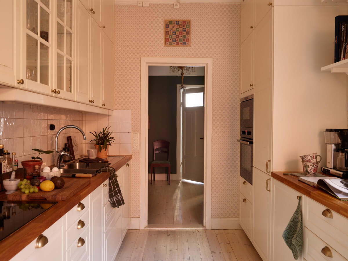A Two-Bedroom Apartment with a Charming Bathroom 9 classic white kitchen wallpapered walls