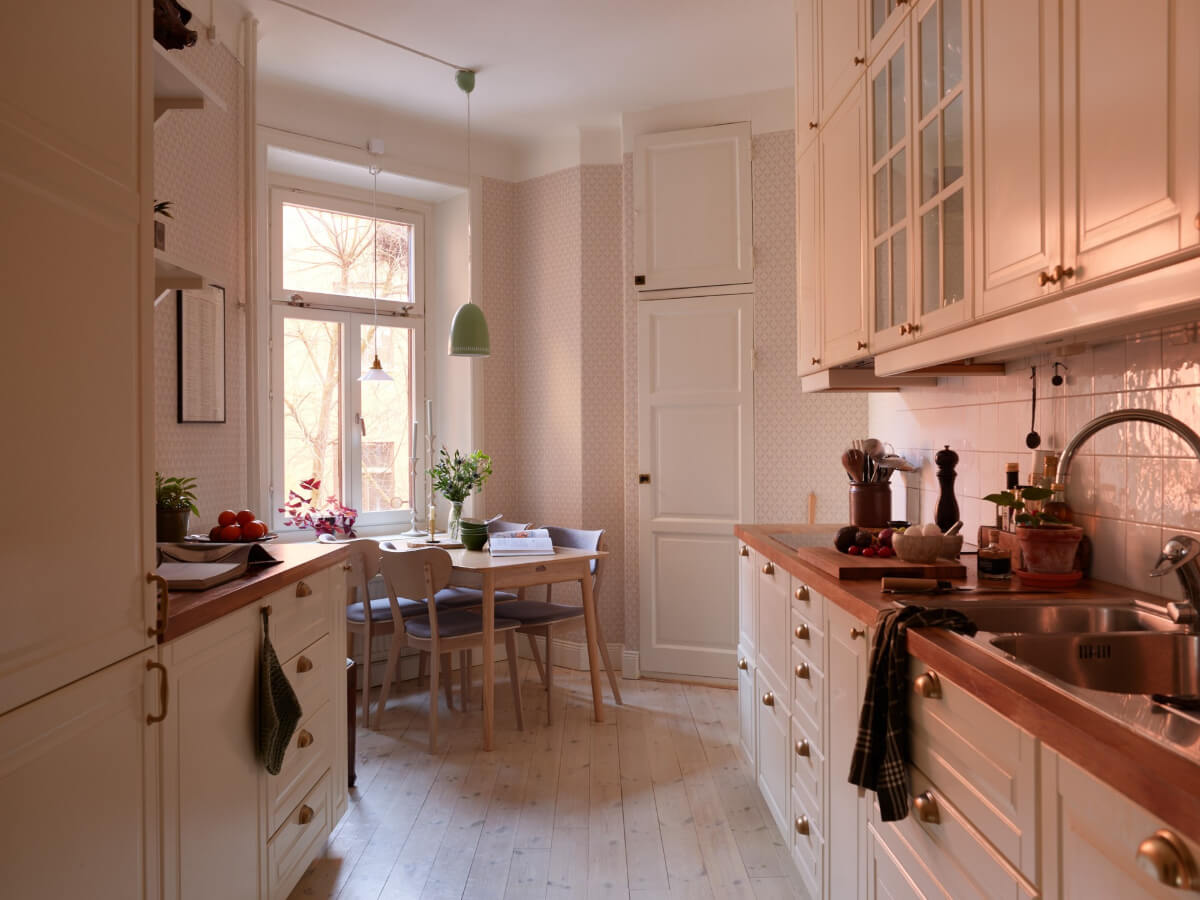 A Two-Bedroom Apartment with a Charming Bathroom 6 classic white kitchen with dining table