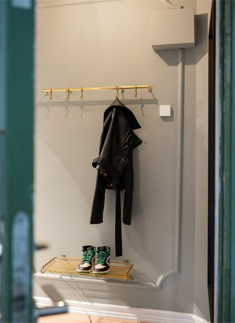A Studio Apartment with Brown Walls 12 coat hanger and shoe storage