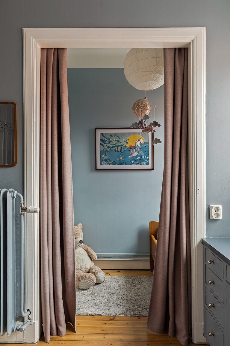 A Stockholm Apartment with a Light Yellow Kitchen 21 curtained doorway into nursery