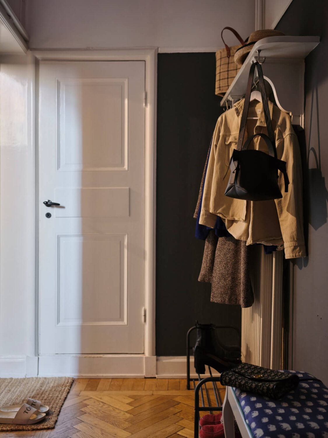 A Small Apartment with an Industrial Stainless Steel Kitchen 16 dark hall hat shelf