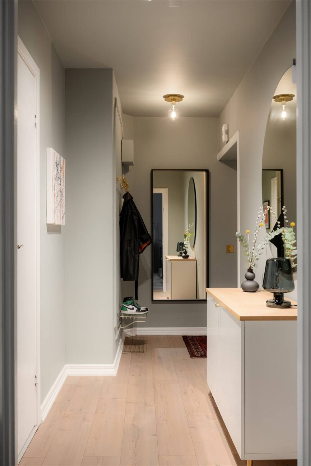 A Studio Apartment with Brown Walls 11 gray hall large mirrors