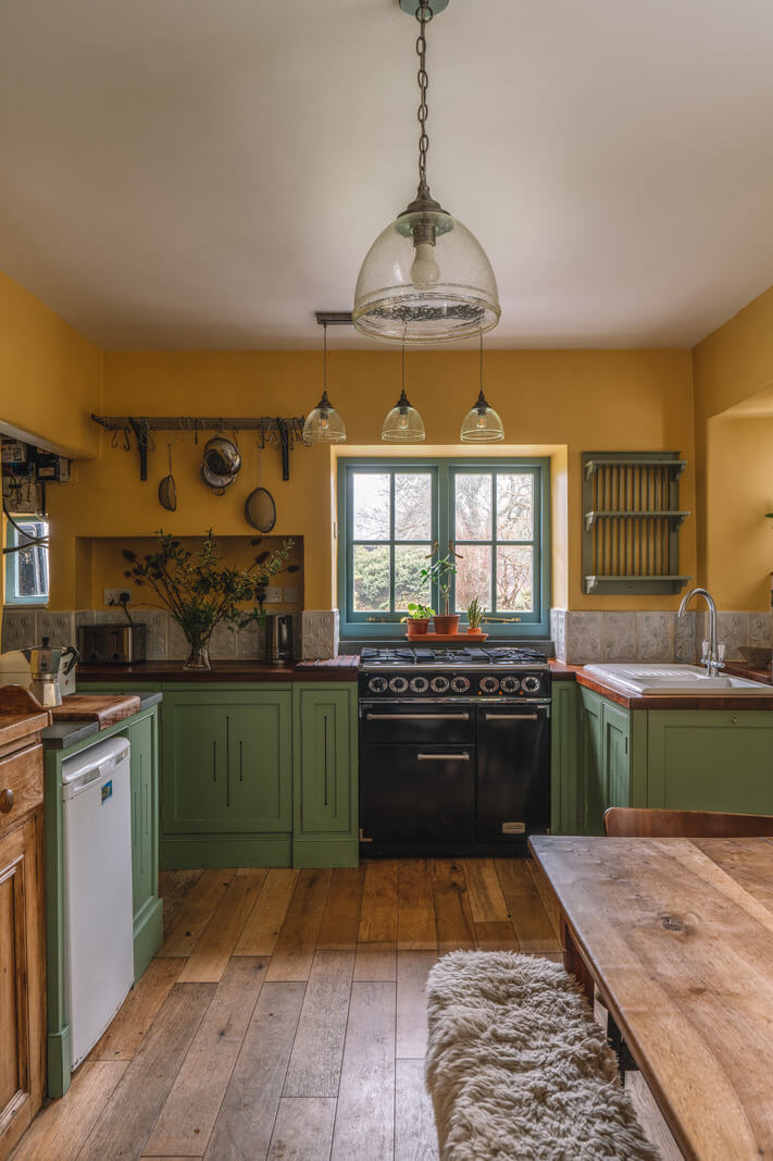 green and ochre yellow cottage kitchen wooden floor