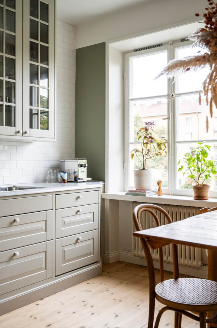 green kitchen with white tiles