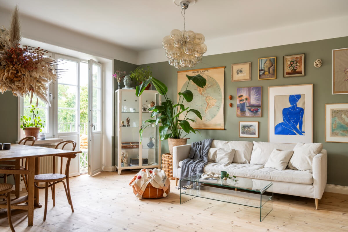 A Light Swedish Apartment with a Green Living Room 1 green walls living room wooden floorboards