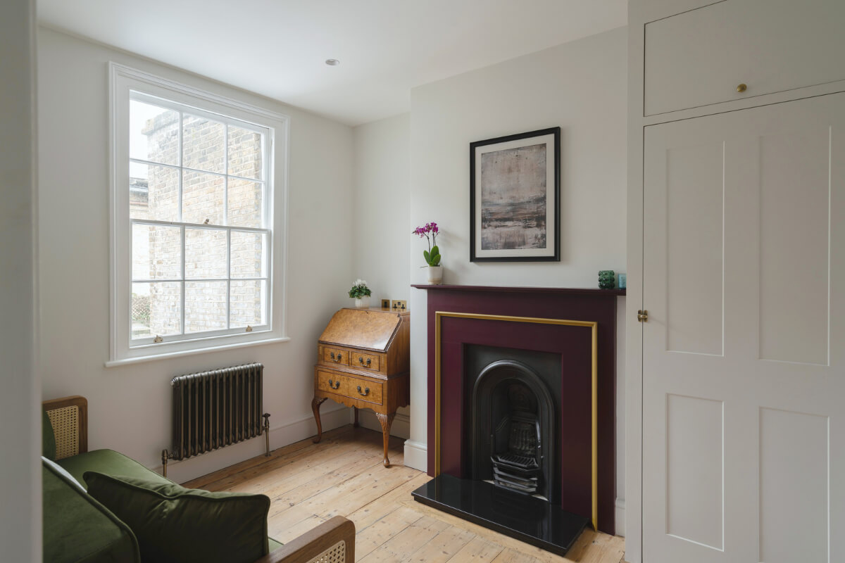 guest-room-deep-red-fireplace-built-in-wardrobes.jpg
