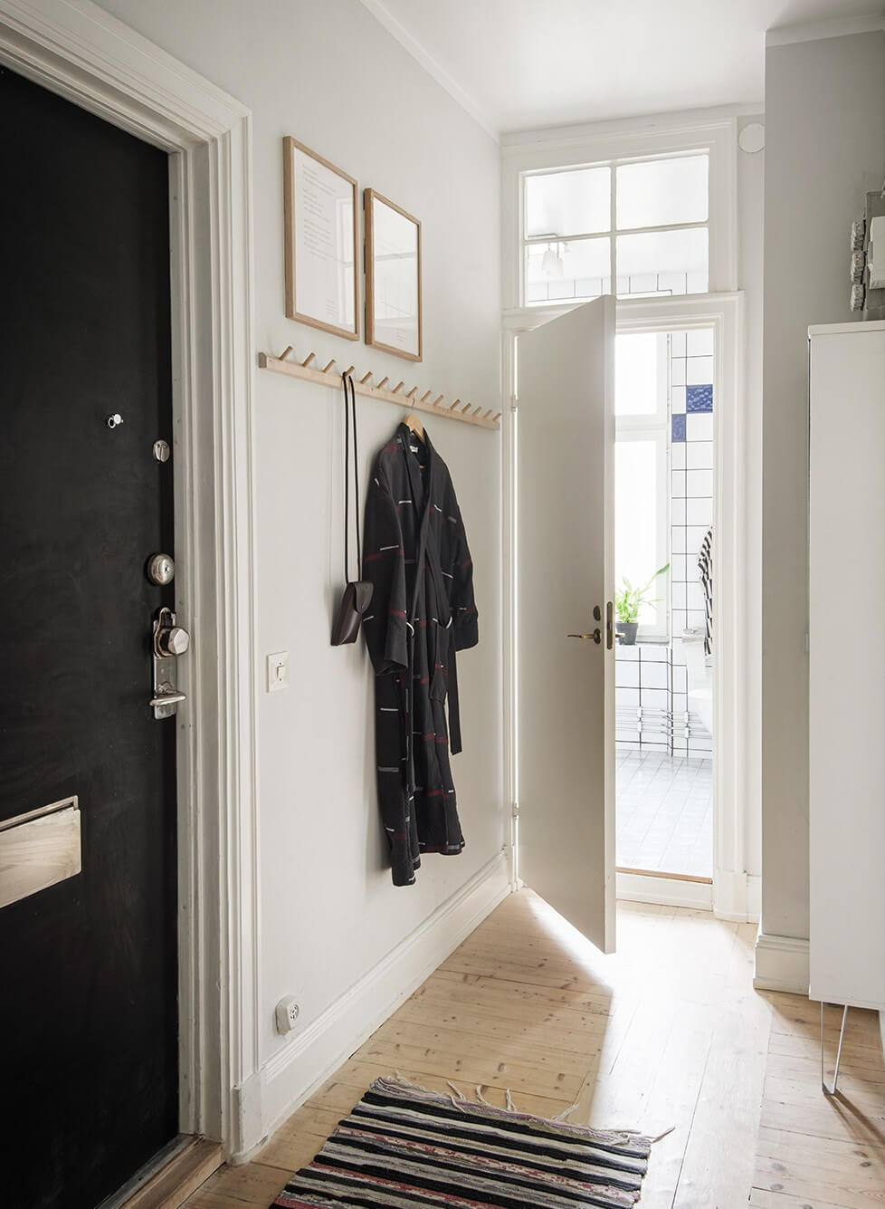Rooms with Unique Shapes in a Lovely Swedish Apartment 21 hall simple wooden coat rack Rooms with Unique Shapes in a Lovely Swedish Apartment