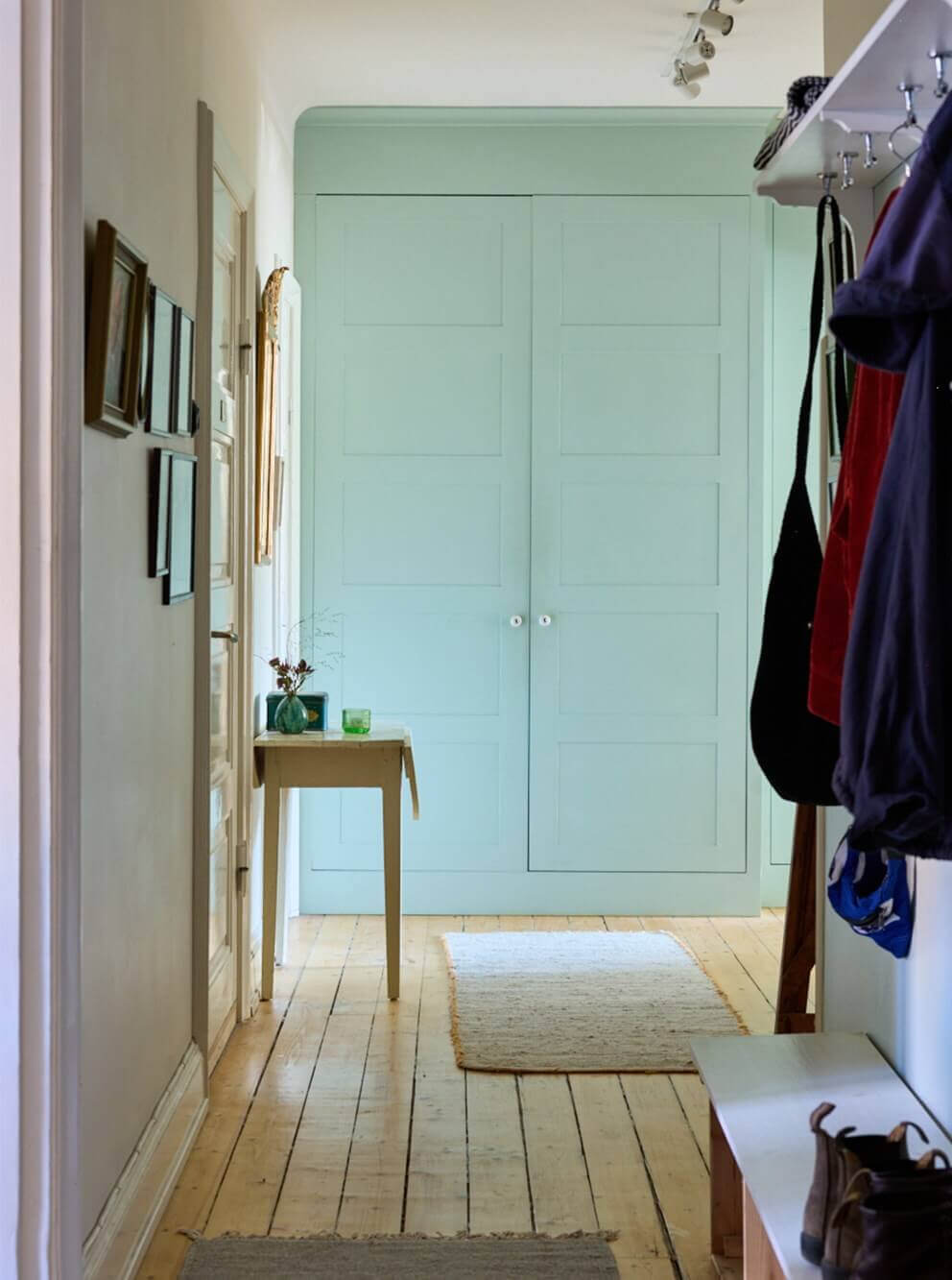 hall with mint green built-in wardrobes