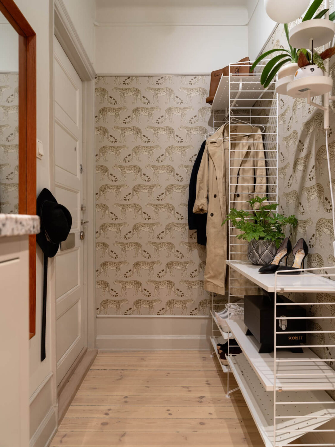 A Charming One-Bedroom Apartment in Södermalm 18 hall with wallpaper and string shelving system