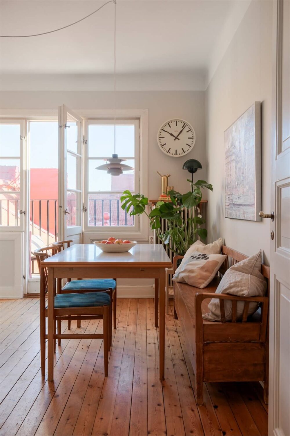 A Stockholm Apartment with a Light Yellow Kitchen 5 kitchen dining area vintage wooden bench