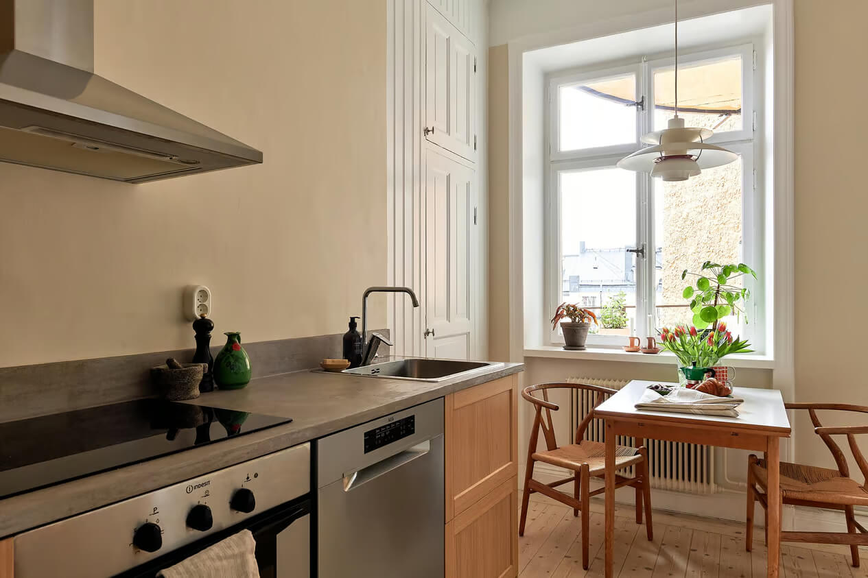 A Charming Swedish Apartment with a Spacious Balcony 14 kitchen with small table under window