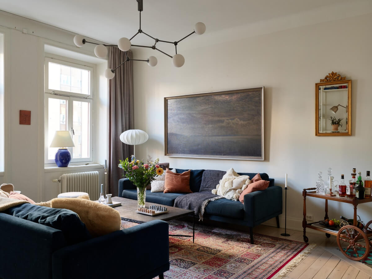 A Two-Bedroom Apartment with a Charming Bathroom 2 living room blue sofas large rug