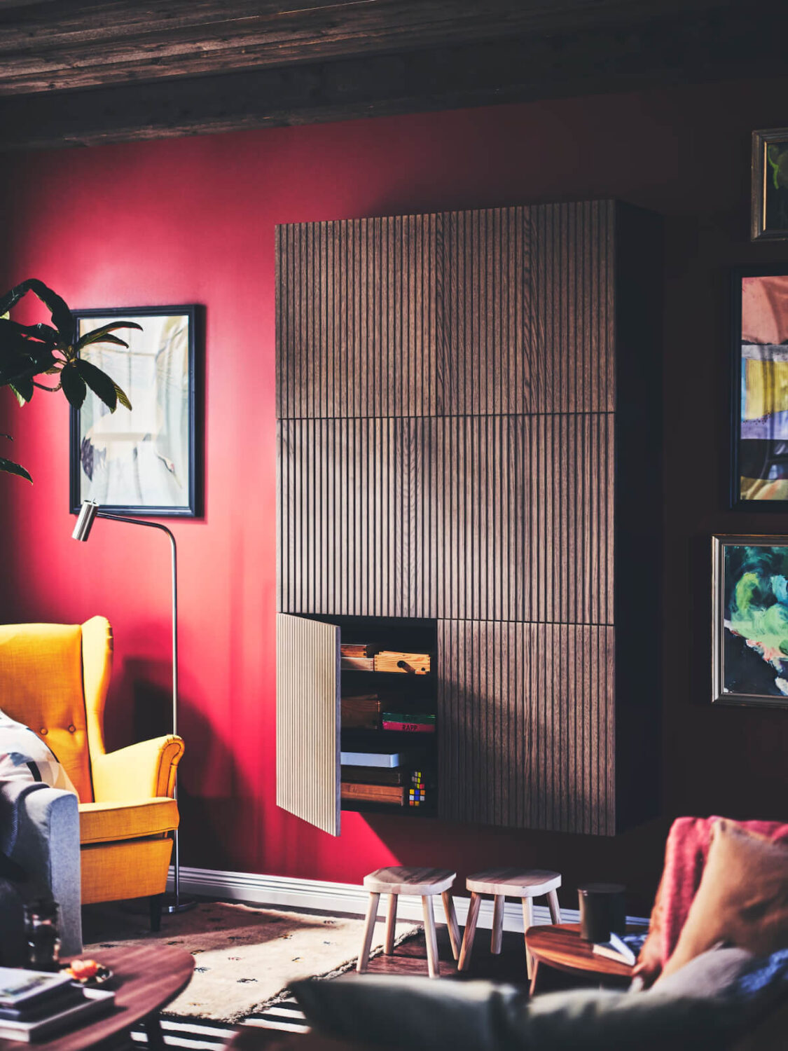 living room reddish pink wall brown wooden cabinet nordroom