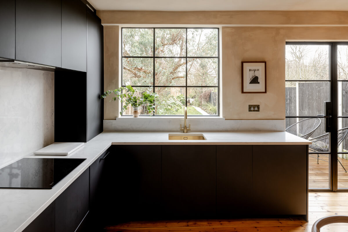 modern kitchen black cabinets window overlooking garden