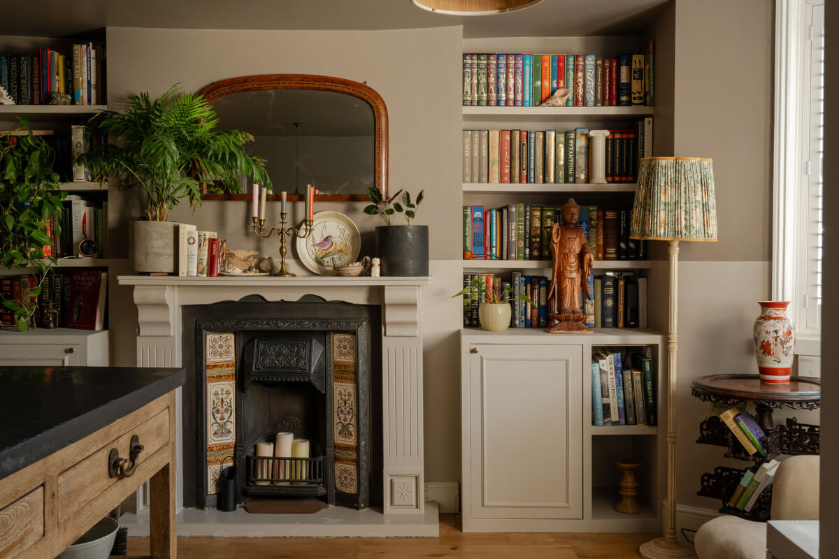muted colored sitting room fireplace bookshelves