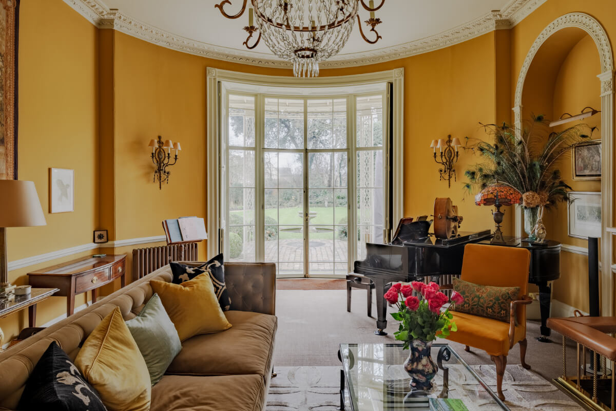 Period Features and Color in a Pretty Georgian House 2 ochre yellow sitting room round glass wall