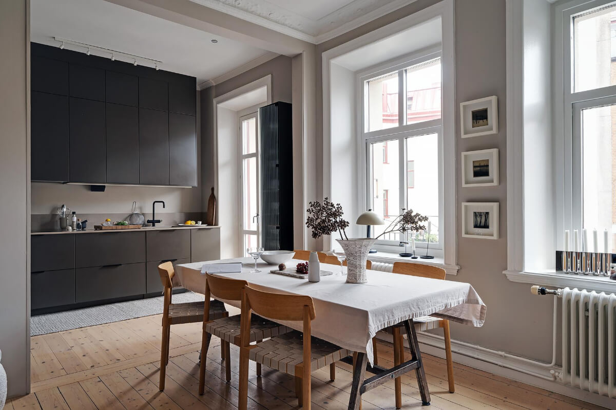 open plan living space dining table black kitchen