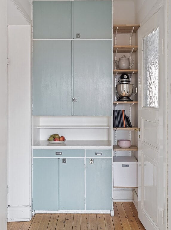 A Stockholm Apartment with a Light Yellow Kitchen 15 original pantry cabinets with shelves